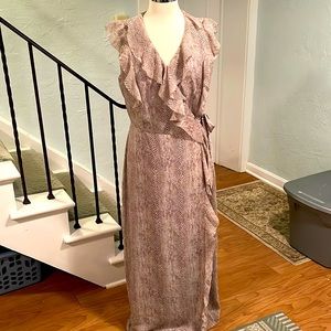 Romance is in the air! Sleeveless, float wrap dress in snakeskin pattern.